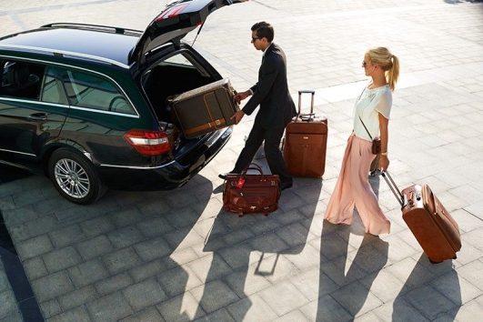 Professional Chauffeur Handling Luggage for Premium Transfer