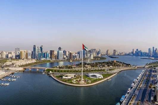 Sharjah skyline and Corniche waterfront with UAE flag