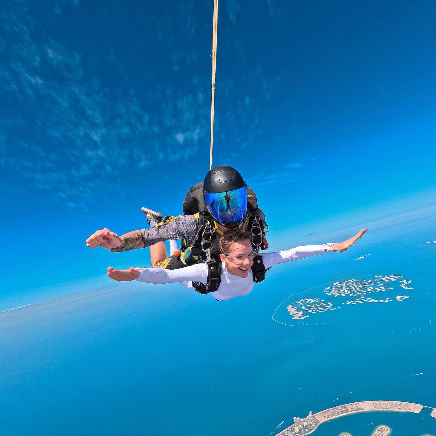 Tandem skydiving above Palm Jumeirah with aerial island views