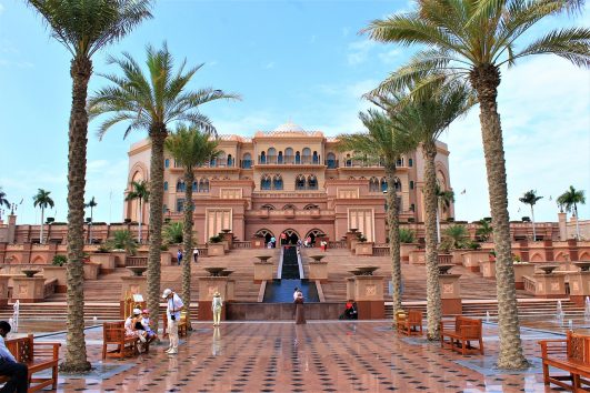 Emirates Palace Abu Dhabi with palm trees and grand staircase