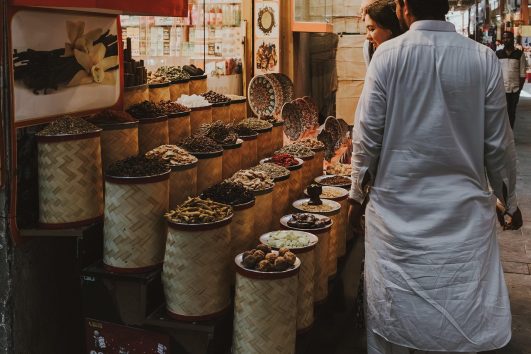 Visitors exploring the colorful Spice Souk in Old Dubai