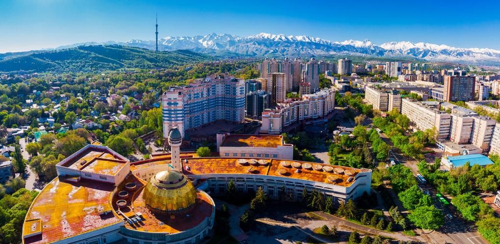 Almaty city skyline with snow-capped mountains in background