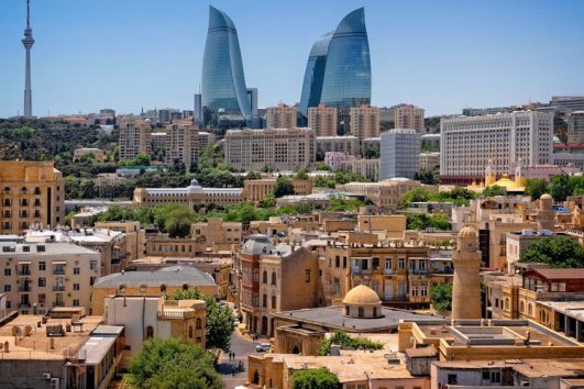 Historic Baku old city with modern Flame Towers in background