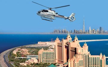 Helicopter flying over Atlantis The Palm with Dubai skyline in the background