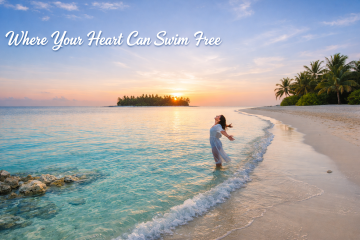 Woman standing in shallow turquoise water at sunset on a tropical beach