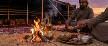 Close-up of Arabic coffee being served over a desert campfire with cardamom and spices at a Bedouin tent