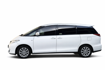 Toyota Previa luxury minivan with Dubai skyline background for airport transfer service