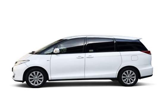 Toyota Previa luxury minivan with Dubai skyline background for airport transfer service