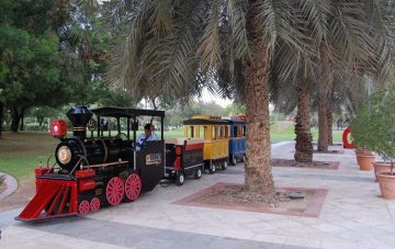 mini train ride inside Creek Park Dubai with palm trees and family-friendly setting