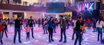 crowd enjoying disco ice skating with DJ and lights Dubai Ice Rink