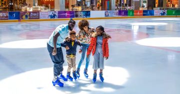 family enjoying ice skating together indoor rink Dubai Mall