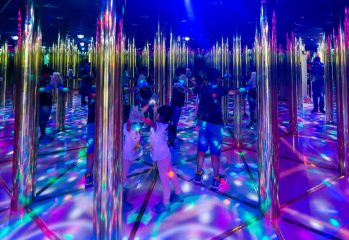 children exploring colorful mirror maze with reflections and lights in Dubai Dolphinarium
