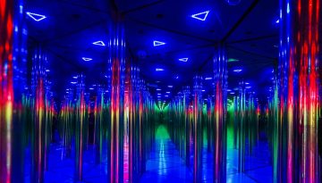 illuminated mirror maze with colorful neon lights creating infinite reflections in Dubai
