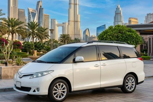 White Toyota Previa parked on street for private airport transfer service in Dubai