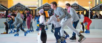 family skating with winter decorations indoor Dubai Ice Rink