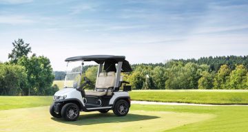 premium electric golf cart parked on golf course landscape