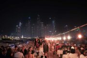 Royal Dhow Cruise illuminated at night with Dubai’s skyline in the background.