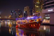 Dhow boat glowing at Dubai Marina at night