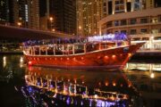 Dhow boat sailing under bridges at Dubai Marina