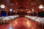 Indoor dining area with elegant table setups inside the Royal Dhow