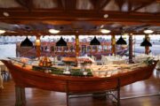 Buffet station in the shape of a wooden dhow onboard a cruise.