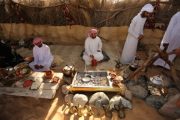 Guests learning to cook traditional dishes with a guide in a Bedouin-style camp