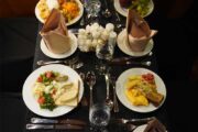 Plates of food arranged on a beautifully set table aboard the dhow cruise.