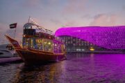 Dhow cruise illuminated at night on Yas Marina.