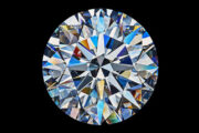 Round brilliant-cut diamond with intricate facets against a black background