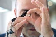 Jeweler examining a diamond closely with a loupe.