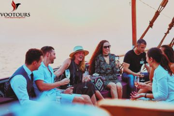 Group of friends enjoying a sunset boat cruise