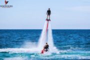 A Fly Boarder elevated high above the ocean, propelled by powerful water jets