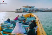 Passengers enjoying a calm ride on a speedboat towards a luxurious island destination.