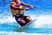 Man enjoying a thrilling Knee Boarding ride in Ras Al Khaimah