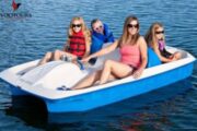 Group of friends enjoying a pedal boat adventure.