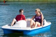 Mother and son enjoying a relaxing pedal boat ride.