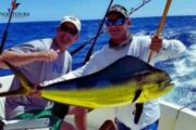 Two anglers proudly displaying a Mahi-Mahi caught during a sports fishing trip