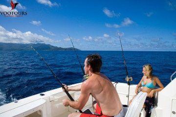 Couple fishing in the open sea surrounded by scenic blue waters