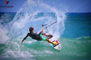 Kiteboarder performing a water splash trick on the ocean.