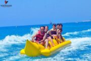 Group enjoying a banana ride on blue waters in Fujairah