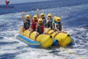 Riders waving and smiling on a vibrant Banana Safari ride in Fujairah