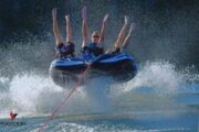 Group enjoying an airborne donut ride with water splashes