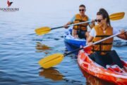 Couple kayaking in calm water during a sunny day in Fujairah