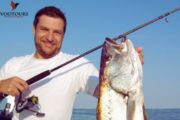 Smiling Fisherman Holding a Big Catch in Fujairah