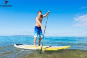 Man Paddleboarding on Clear Waters in Fujairah