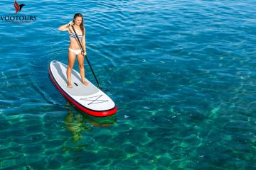 Woman Paddleboarding on Crystal Clear Waters in Fujairah