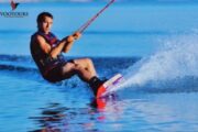 wakeboarding at sunset with a high jump