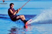 Experienced water skier cutting through waves in Fujairah's blue waters.