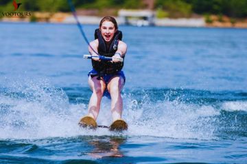 Smiling woman water skiing on clear waters in Fujairah