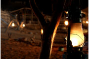 Traditional lantern glowing at a desert camp at night.